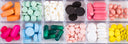 A tray of brightly coloured tablets in different sizes separated into 12 compartments 